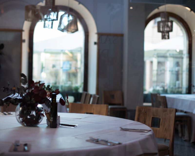 Arched restaurant interior with a flower-dressed table