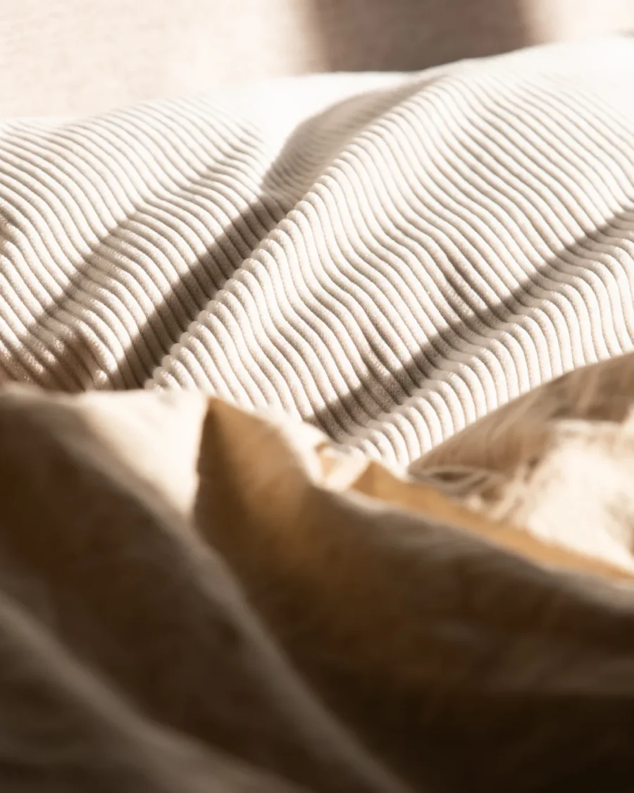 Close-up of a ribbed cushion in warm afternoon light