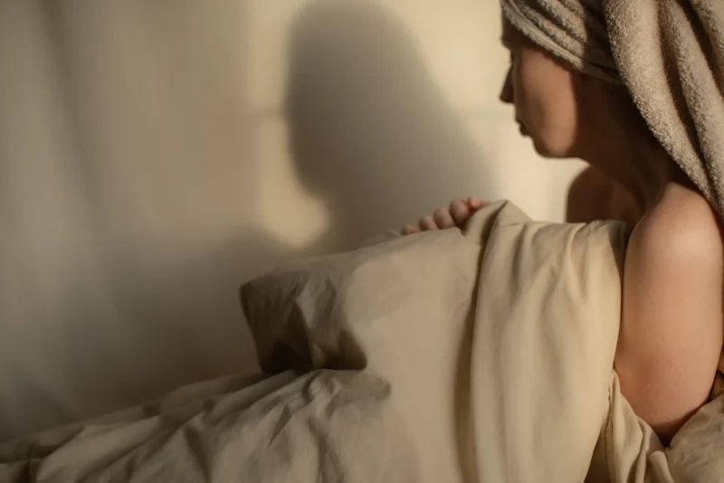 Woman with a towel-wrapped head, profile in warm light